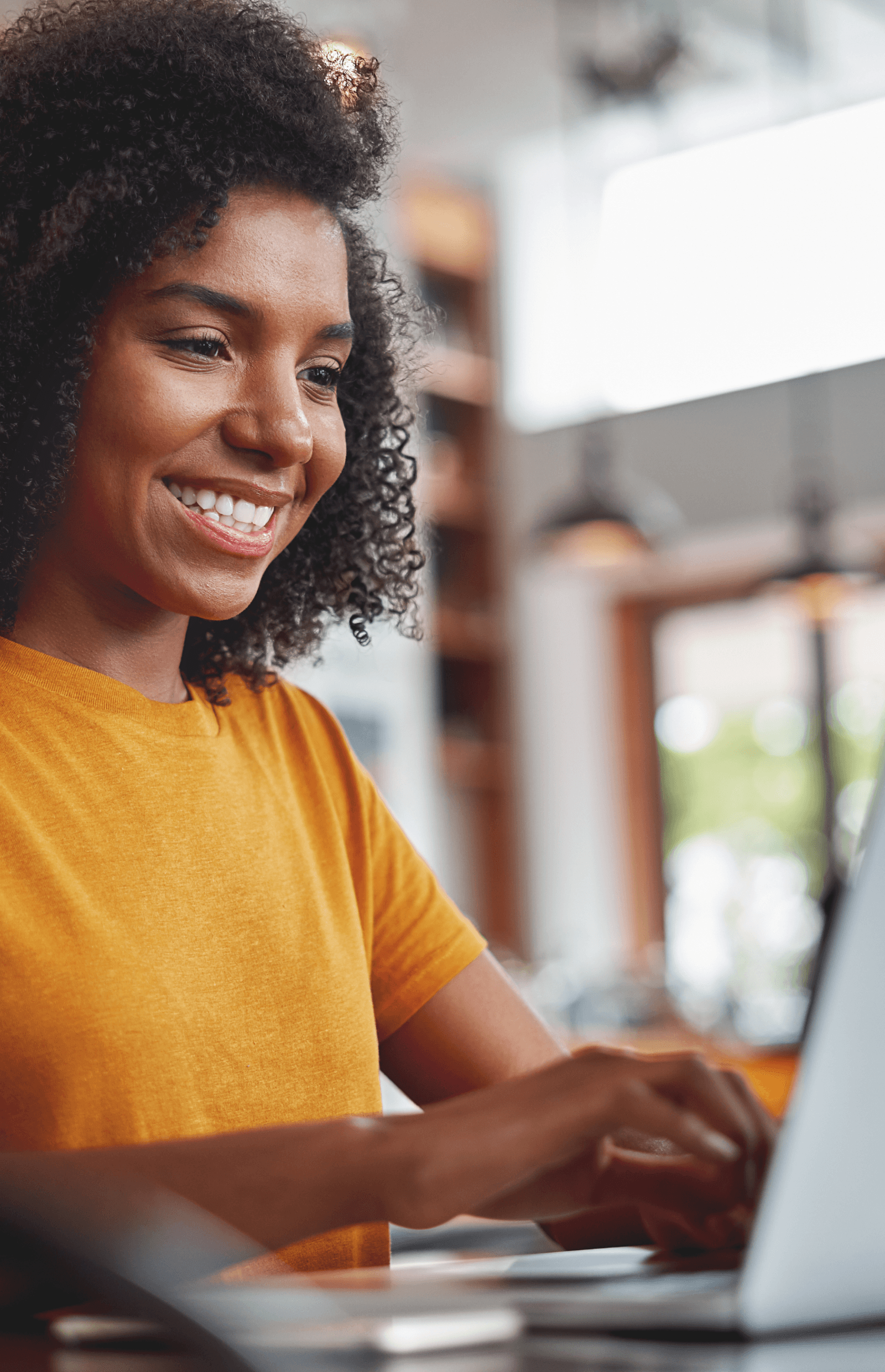 Woman on a laptop smiling 